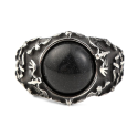 Close-up on the superb details carved with raised bats surrounding the black stone.