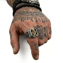 Ring with cross in flower of lily carved on the flank of the steel knight