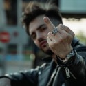 Man with a rebel look and biker carrying the steel knight with reversed provocative inscription