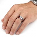 Steel and carbon ring brought to finger by a man illustrating a trendy, sporty and minimalist male style