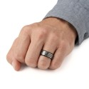 Another angle of the three-band ring in finger by a man illustrating his resolutely modern look