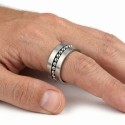 Other angle of the ring with movable ball in stainless steel range carried by a man