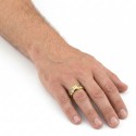 Other angle of the golden steel ring worn by a man illustrating his relief of his silver carbon fiber tape