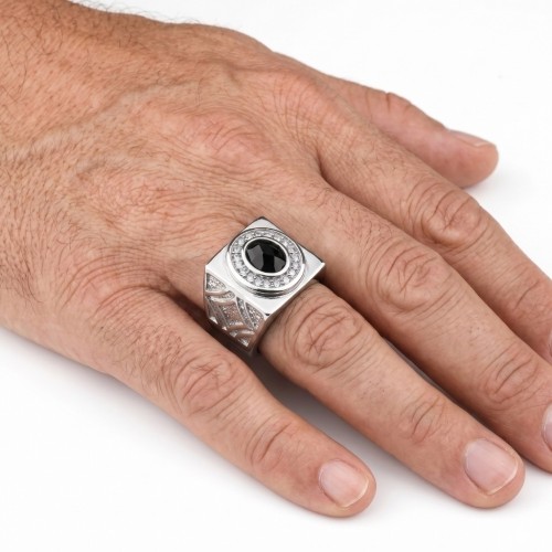 Vue de la bague bling bling portée à la main d'un homme, mettant en valeur les éclats de lumière sur la pierre facettée