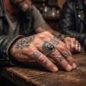 Snap of Indian head carried to the index or middle finger of a man for a biker style, rebel and affirmed