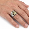 Close-up of the hand carried ring of a man, highlighting the radiance of the gold veneer of the leaf under light