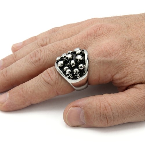 Close-up of the hand carried ring, highlighting the brilliance of steel on the top of the skulls under light