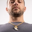 Detail of Lion Head Pendant With Opal Tooth and Golden 7mm Coffee Bean Chain carried by a man