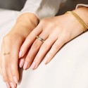 Rotating anti-stress ring for woman in gold stainless steel, decorated with square zircons stones.