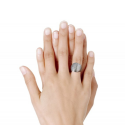 Large stainless steel shell domed ring worn by a woman