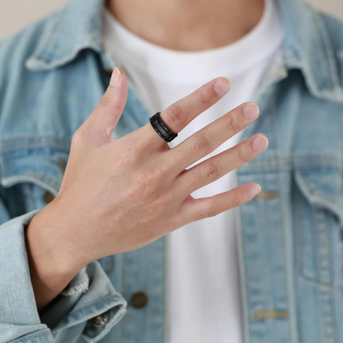 Tungsten Alliance ring black brushed center and alternating grooves carried by a man