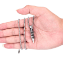 Bullet-shaped steel pendant decorated with biker skulls worn by a man
