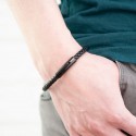 Bracelet braided leather and clasp black magnetic steel modern worn by a man