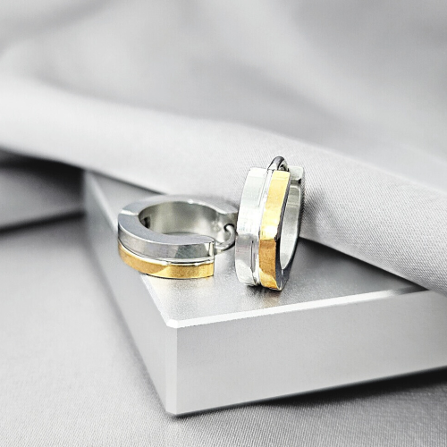 Pair of women's men's two-tone steel and gold band earrings presented