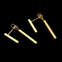 Pair of earrings with two hanging bars in gold-colored steel and black background
