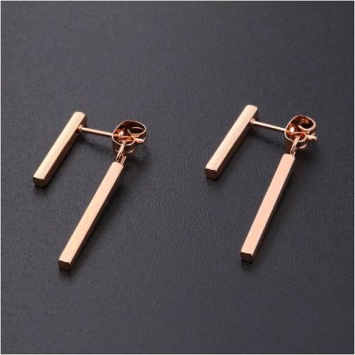 Pair of women's earrings with two dangling steel bars, pink gold color, black background