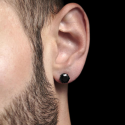 Pair earrings teen steel all black round diams worn by a man