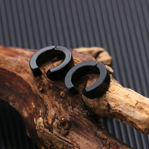 False pair men's all-black steel earrings for non-break presented