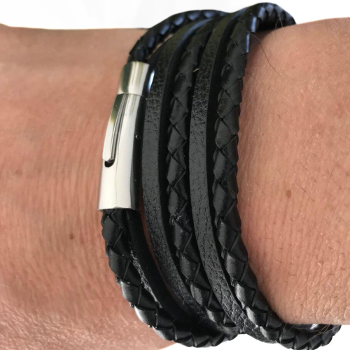 Wrist view of a man wearing the black leather multirang bracelet, highlighting the magnetic clasp in steel